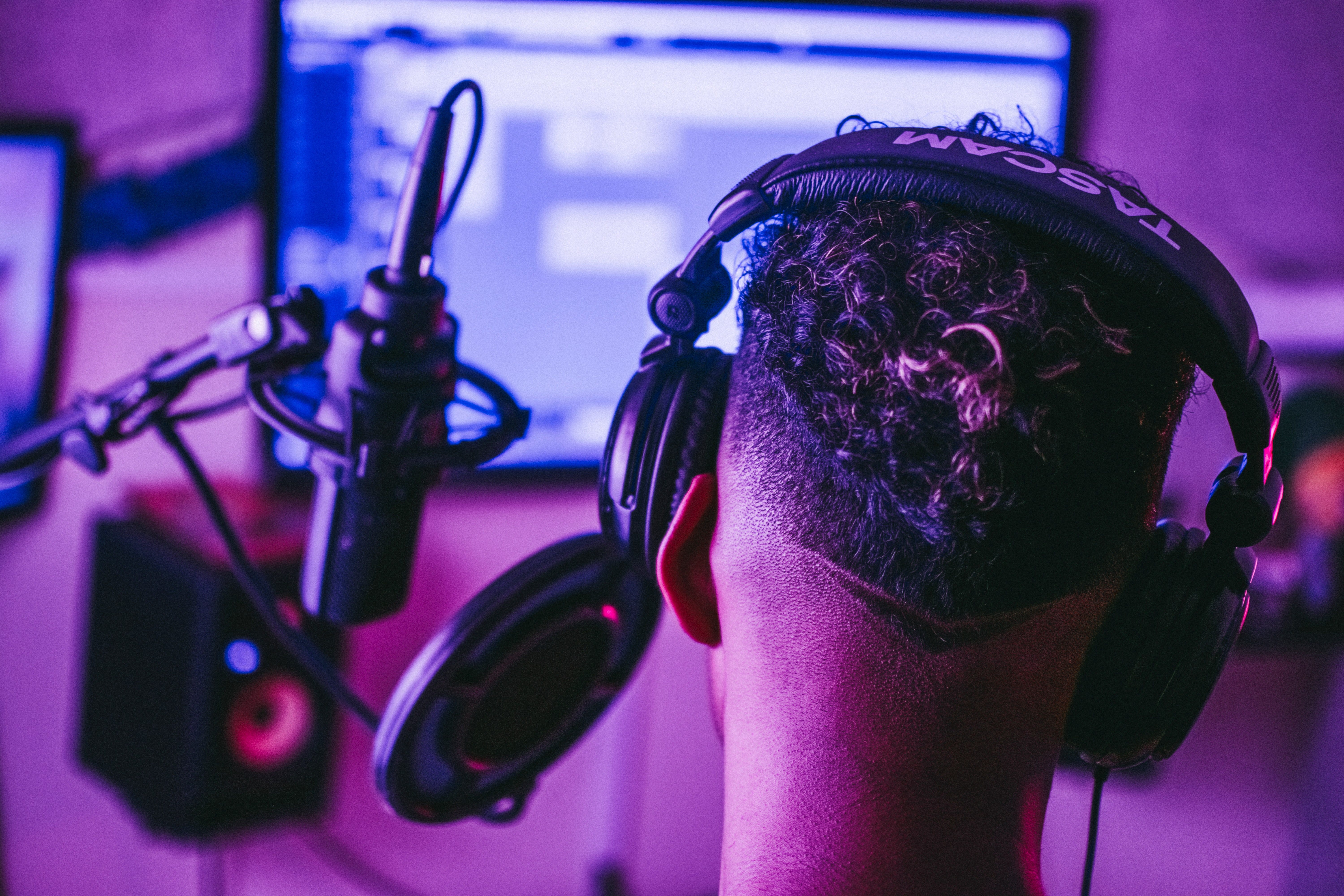 microphone and headphones in a view behind a man's head